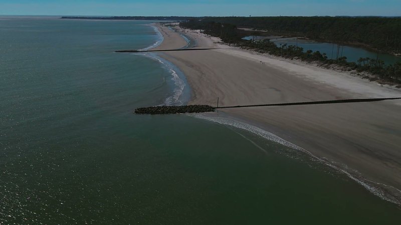 Coastal aerial — jetty & lagoon